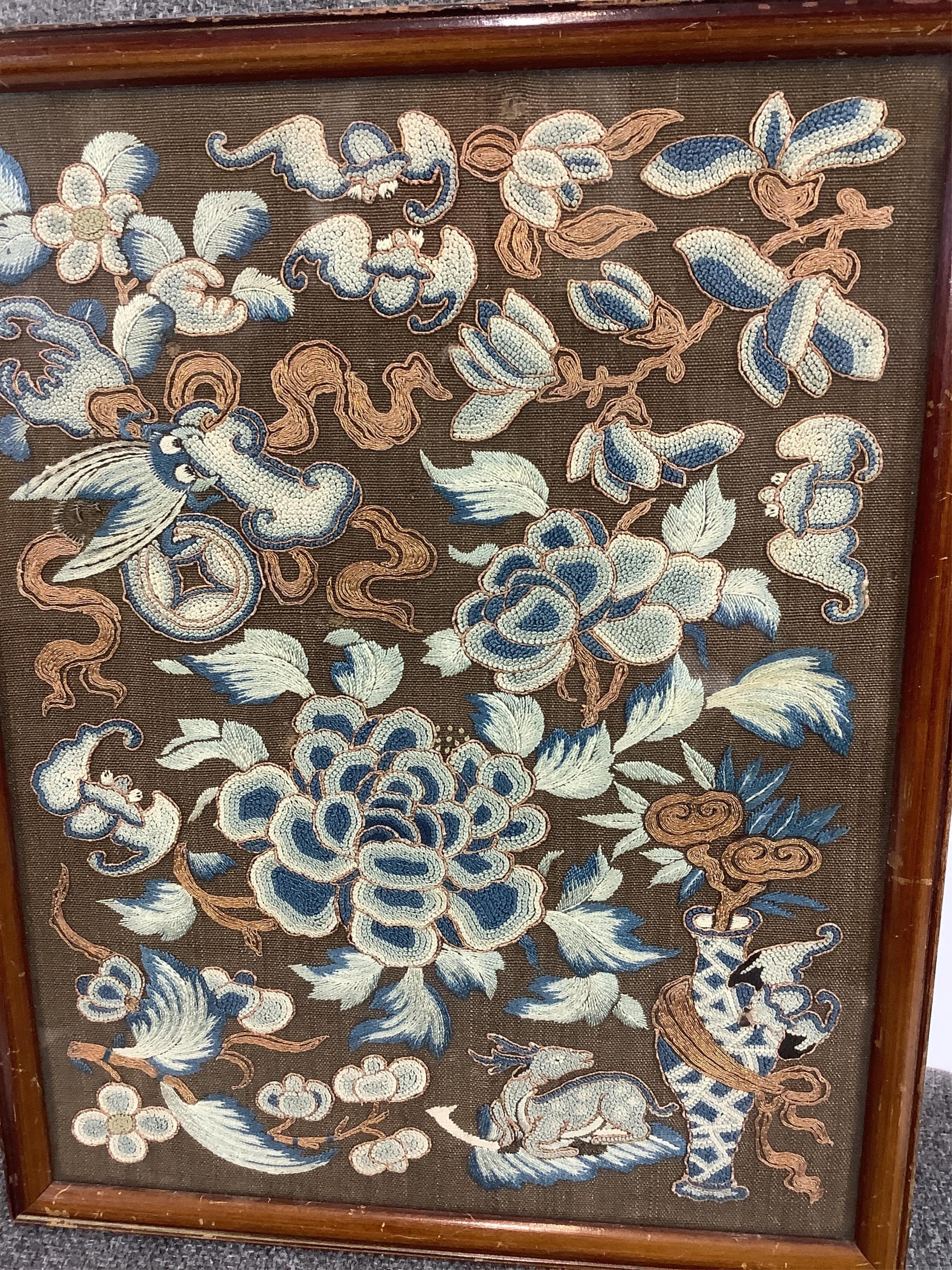A 19th century framed Chinese Peking knot panel, embroidered on brown silk, in tones of blue, with metallic outlines and high lights on auspicious motifs emblematic of long life and happiness. 28cm x 21.5cm. Condition -